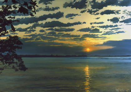 Sunrise with dakrk clouds ,trees in foreground by the water
